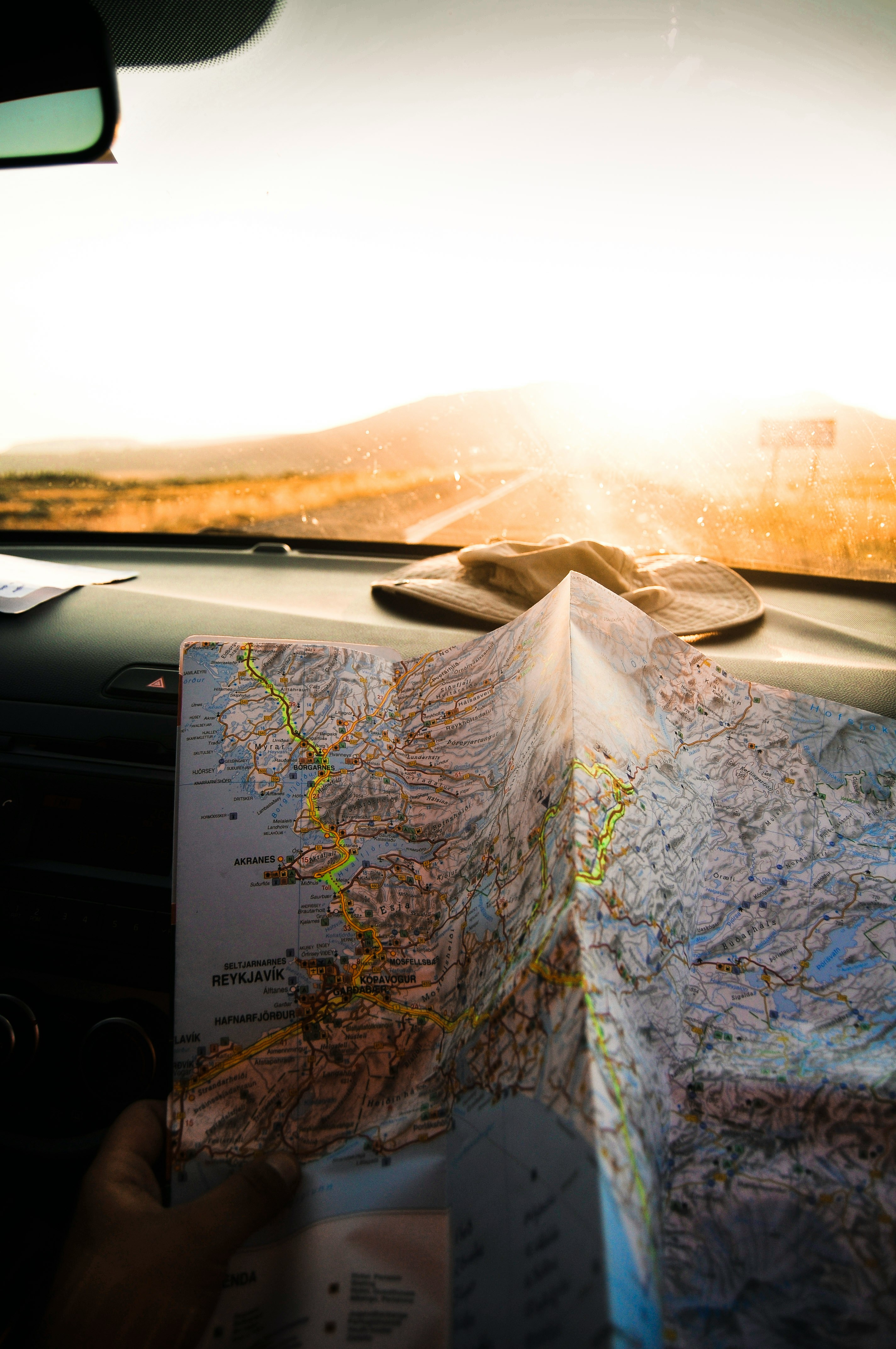 A road map open on a car dashboard at sunset, the kind of bespoke route a Quintessentially Travel concierge plans
